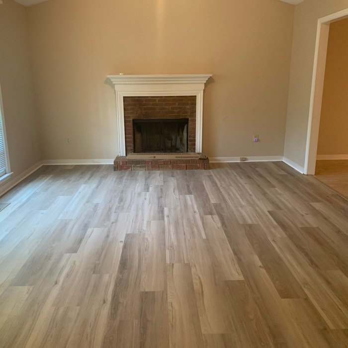 LVP flooring with a brick fireplace