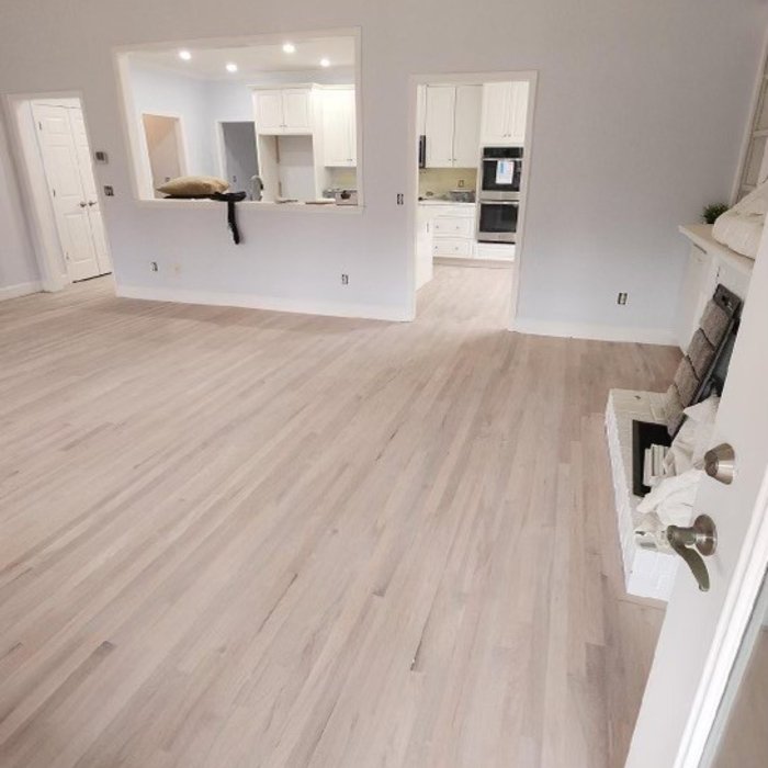 Light whitewashed wood flooring in an open floor plan